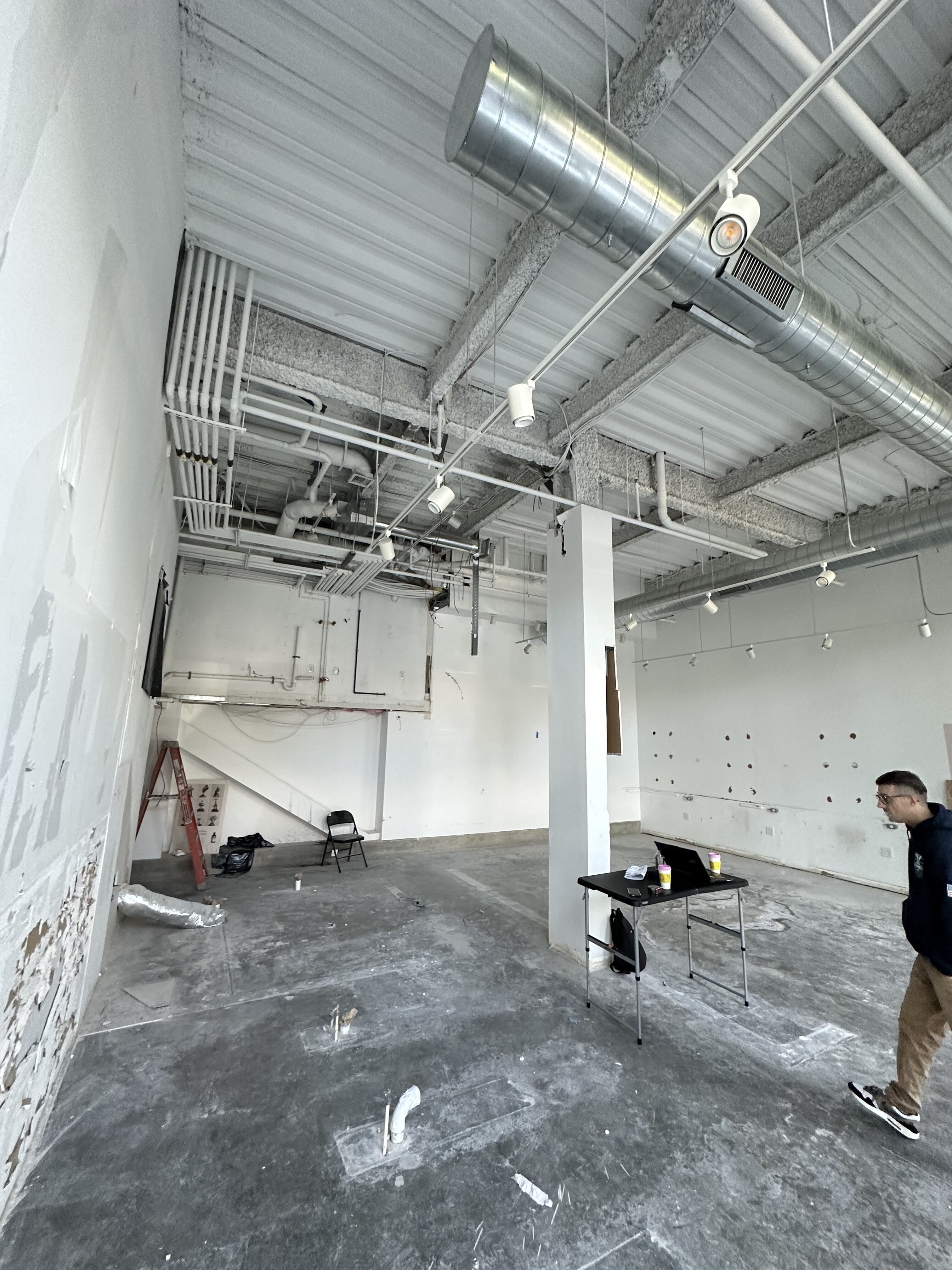 Worker walking beneath ceiling fan